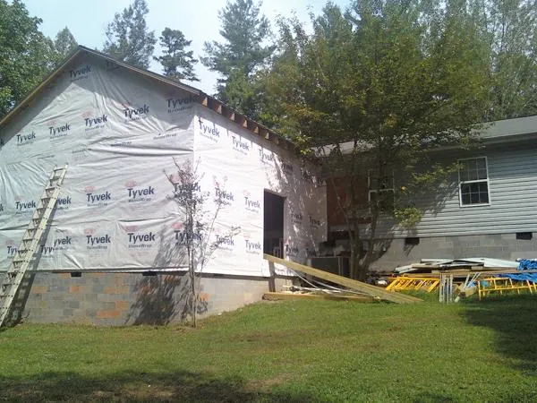 Tyvek wrapped gable on a new room addition beside an existing home in Wildwood
